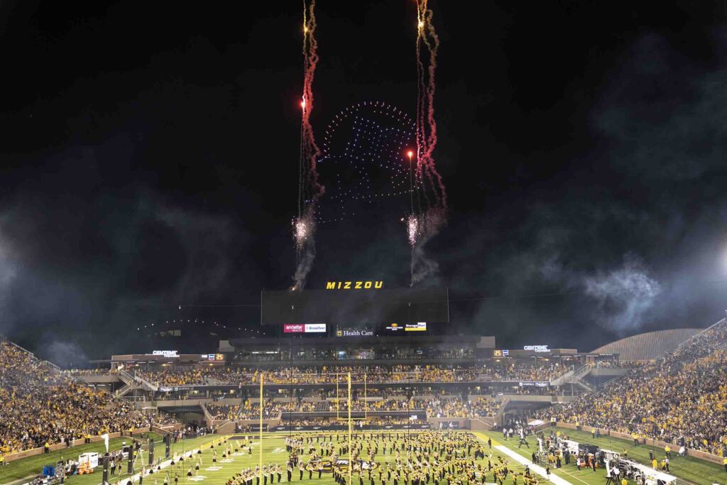 Football stadium with fireworks at night.