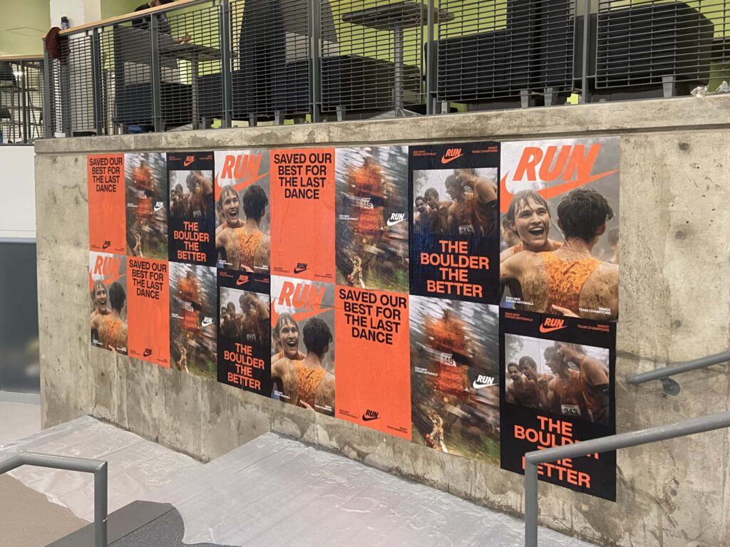 Running event posters on a concrete wall.