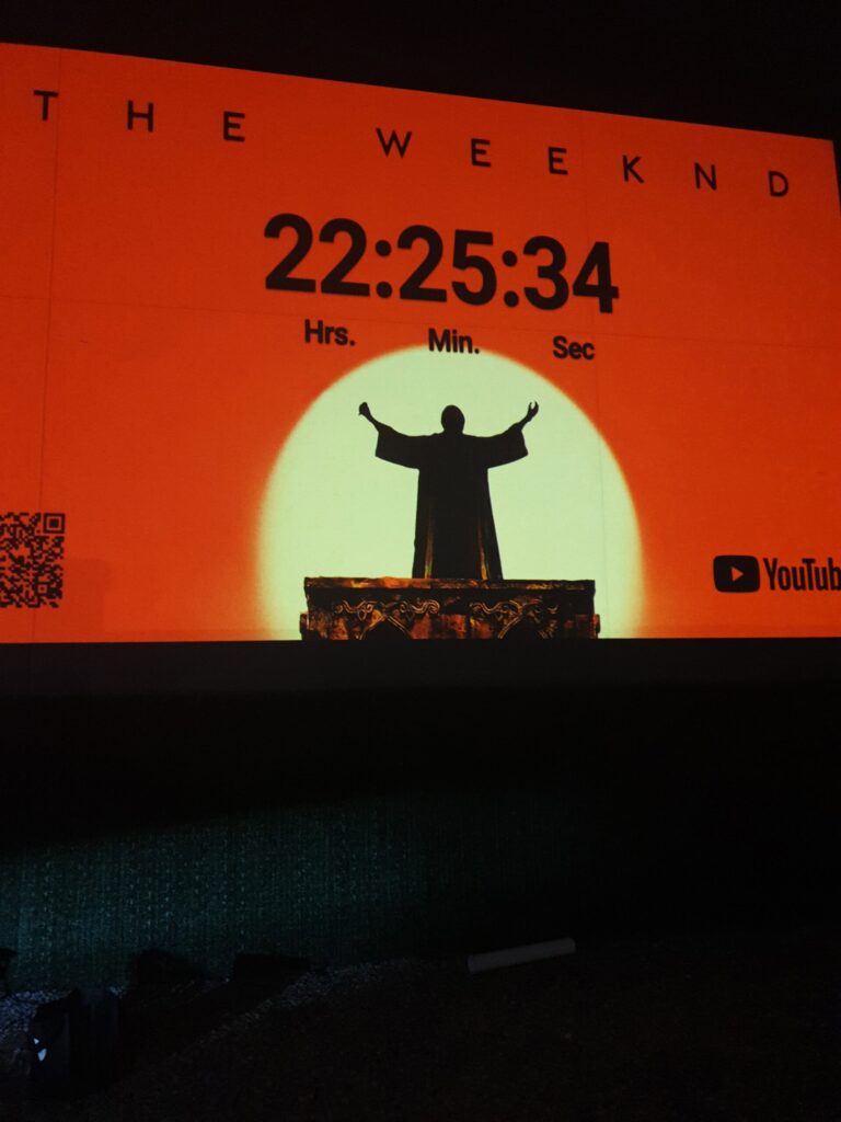 Countdown timer with silhouetted figure projected.