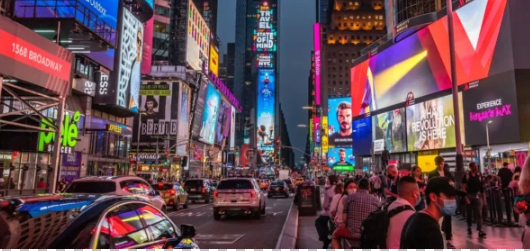 Times Square at night featuring vibrant digital billboards and heavy pedestrian traffic, showcasing the iconic advertising landscape ideal for outdoor marketing.