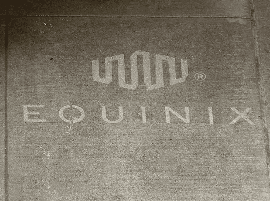 Sidewalk stencil of Equinix logo and brand name, symbolizing guerrilla marketing strategies in Burlington, Vermont.