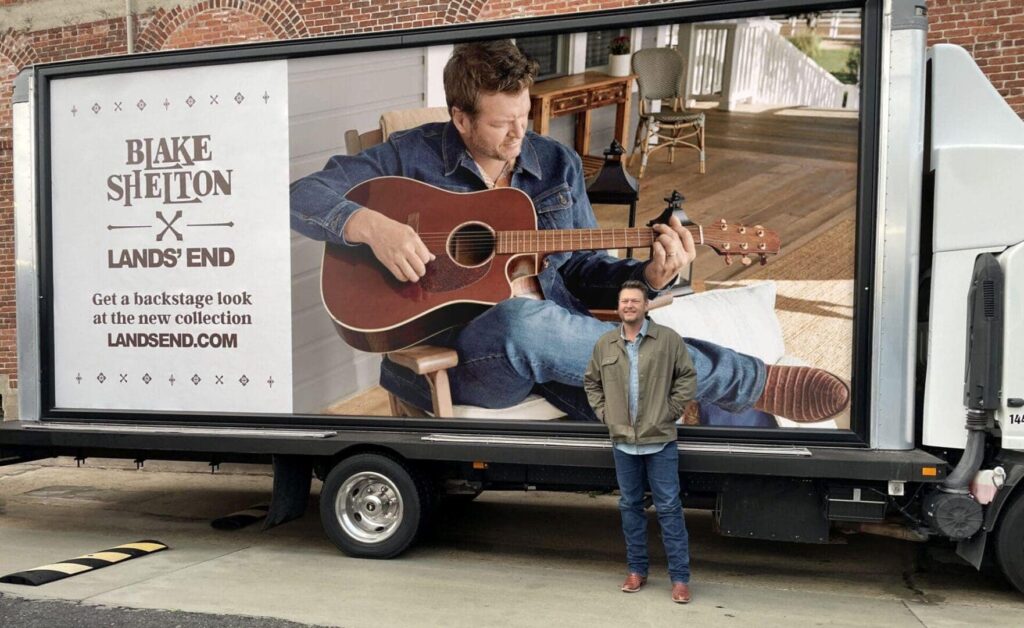 Blake Shelton promoting Lands' End collection on mobile billboard with guitar, showcasing guerrilla marketing strategy.