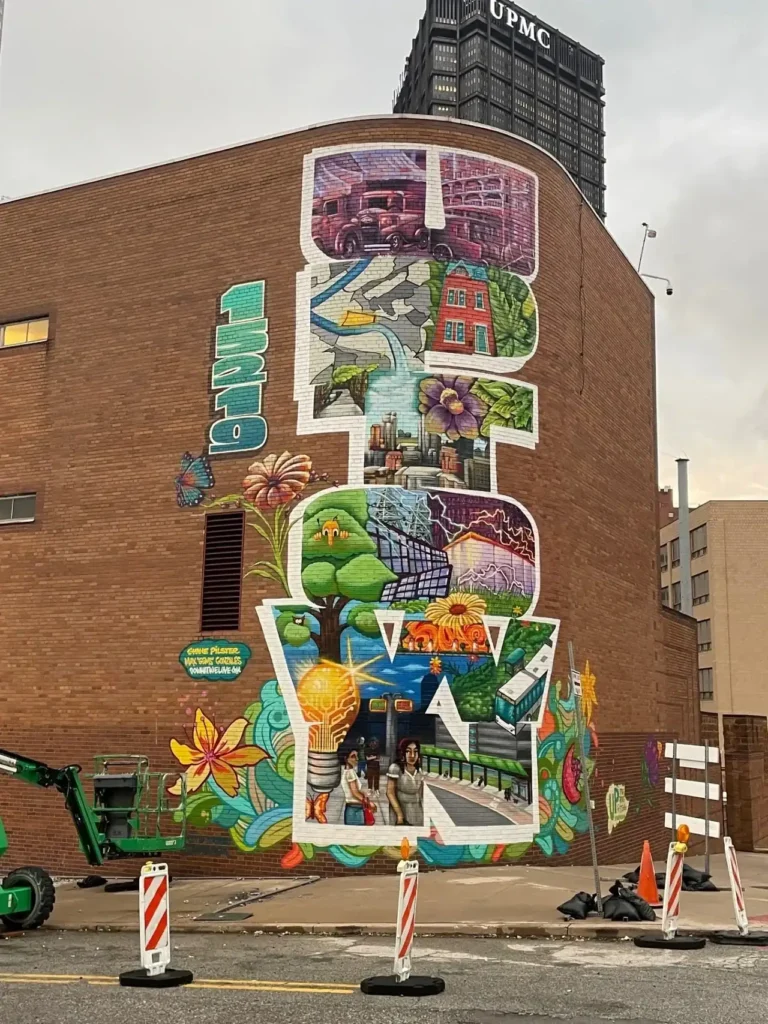 Mural showcasing vibrant scenes of urban life, nature, and creativity on a building in Washington, DC, highlighting guerrilla marketing strategies through artistic expression.