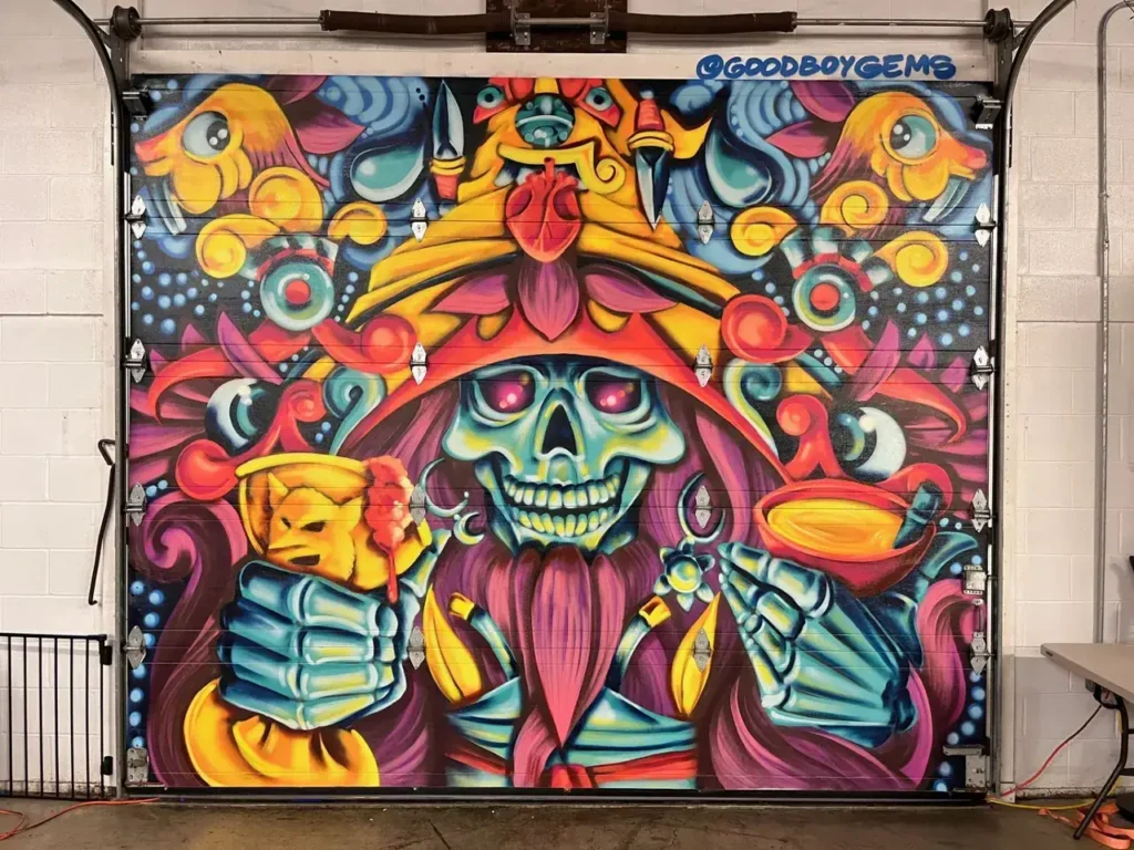Mural featuring a colorful, stylized skull character holding drinks, surrounded by vibrant patterns and elements, representing creative mural advertising by American Guerrilla Marketing.