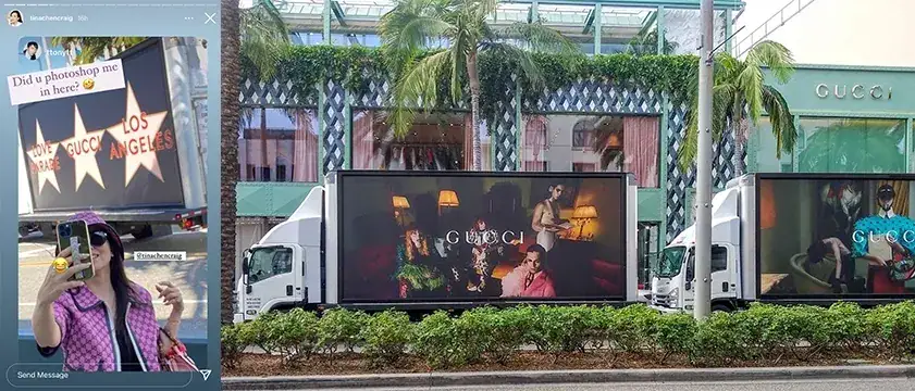 Woman posing with a drink in front of a Gucci advertisement on trucks, featuring vibrant visuals and palm trees in a luxury shopping area.