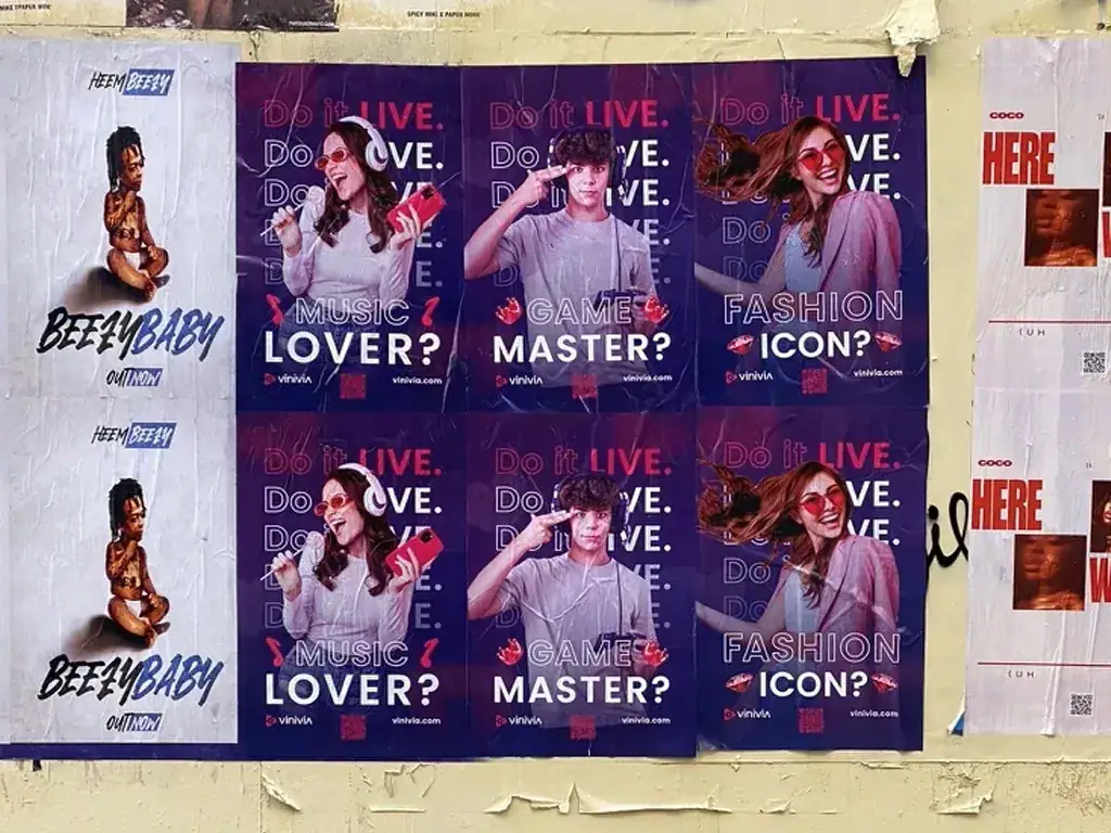 Posters featuring diverse individuals promoting music, gaming, and fashion, with questions like "Do it LIVE. Do you love music?" and "Are you a fashion icon?" showcasing guerrilla marketing strategies for brand engagement.