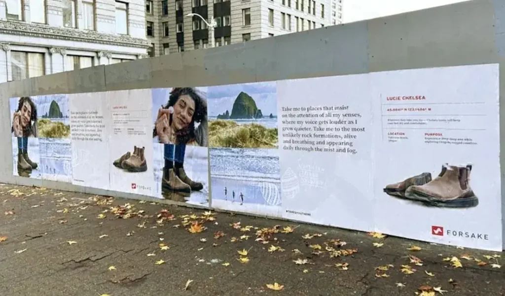 Outdoor advertising display featuring a woman interacting with nature, showcasing Forsake footwear, with promotional text highlighting the Lucie Chelsea model and its features.