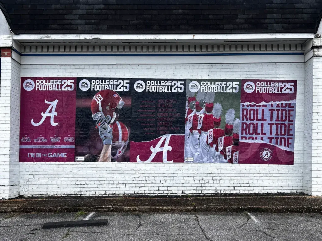 Wall mural featuring Alabama football branding, including "ROLL TIDE" text, images of players and cheerleaders, promoting EA Sports College Football 25.