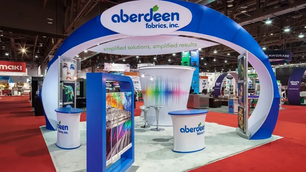 Trade show booth for Aberdeen Fabrics, featuring colorful displays and branding elements, emphasizing innovative advertising strategies in marketing.