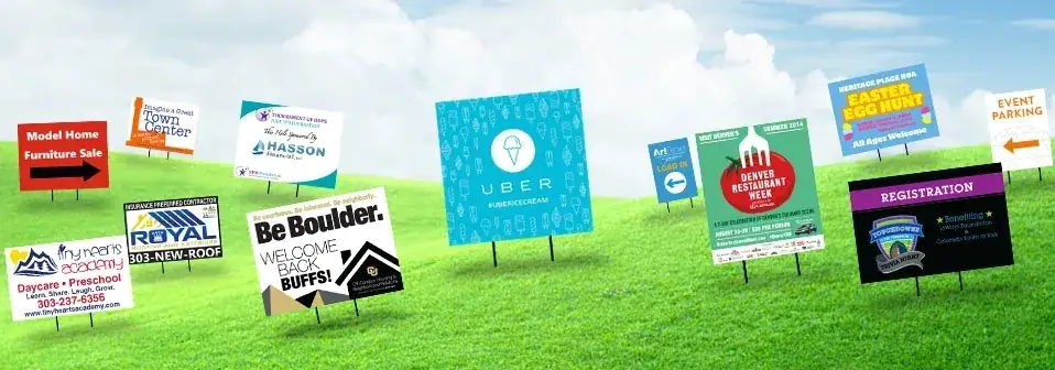 Yard signs displaying various advertisements, including event promotions and business services, set against a green grassy background, illustrating effective local advertising strategies.