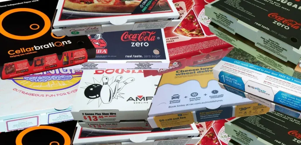 Pizza boxes featuring various advertisements and promotions, including Coca-Cola Zero, Cellarbrations, and AMF Bowling, showcasing guerrilla marketing strategies for food and entertainment businesses.