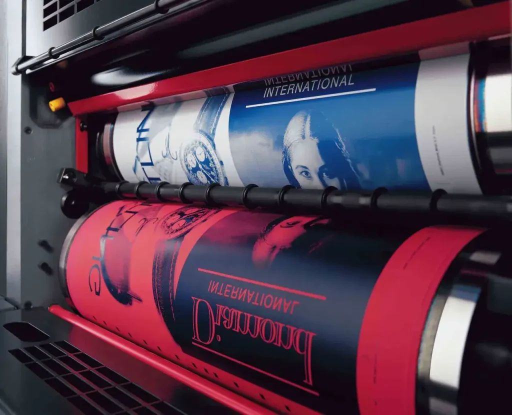 Printing press with rolls of colorful advertising materials, showcasing vibrant graphics and branding, relevant to print advertising strategies discussed in guerrilla marketing.