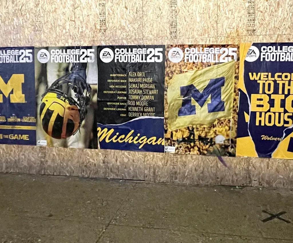 Posters featuring University of Michigan football players and branding, promoting EA Sports College Football 25, with a focus on team spirit and engagement.