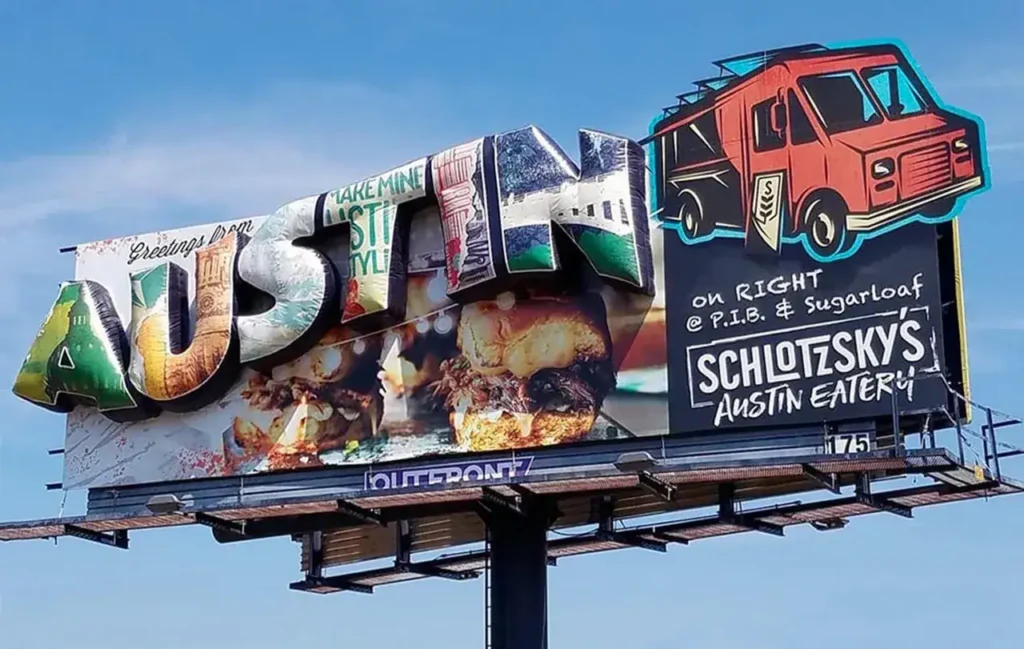 Billboard advertising in Austin featuring "Greetings from Austin" text, showcasing local cuisine and promoting Schlotzsky's Austin Eatery.