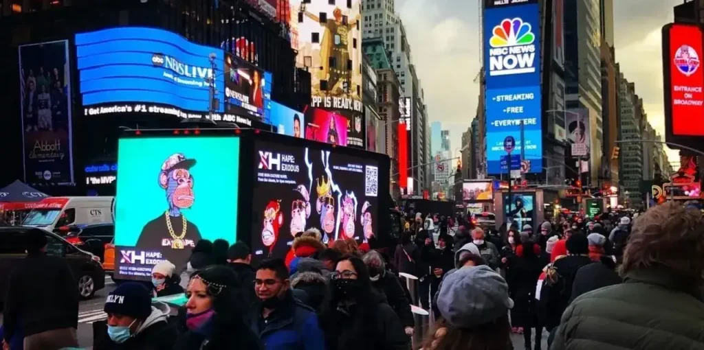 Crowded Times Square scene featuring vibrant digital billboards, including a prominent animated display of cartoon characters, highlighting outdoor advertising effectiveness in urban marketing strategies.