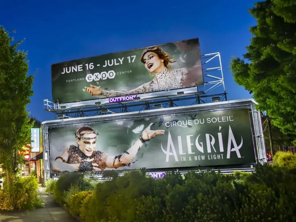 Billboard advertising for Cirque du Soleil's "Alegría" featuring vibrant imagery and performance details, positioned in a Portland urban setting, showcasing innovative marketing strategies.