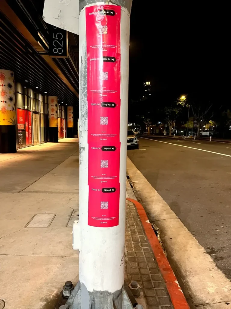 Pink posters on a pole: Skip ads.