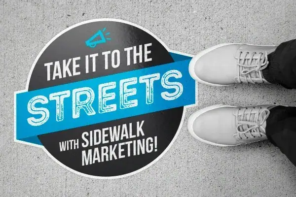 Take it to the streets graphic with sidewalk marketing message and sneakers on concrete.