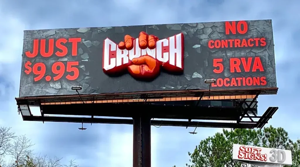 Billboard advertising for Crunch fitness, featuring bold text stating "JUST $9.95" and "NO CONTRACTS," highlighting five locations in RVA, with a striking design emphasizing affordability and accessibility in fitness marketing.