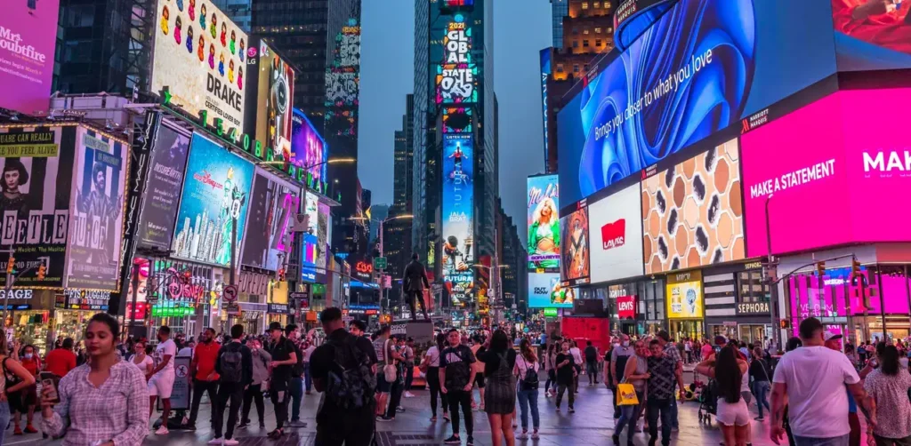 Crowded Times Square with vibrant digital billboards and advertisements, showcasing urban advertising strategies in a bustling marketing environment.