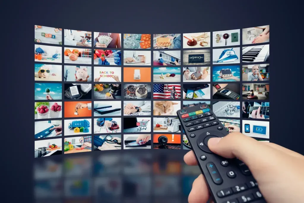 Remote control in hand, navigating a collage of diverse images on a large screen, illustrating various advertising themes and consumer engagement strategies.