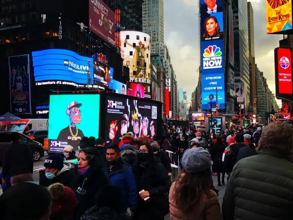 Crowd in Times Square with LED billboards displaying vibrant advertisements, showcasing guerrilla marketing techniques and interactive advertising strategies.