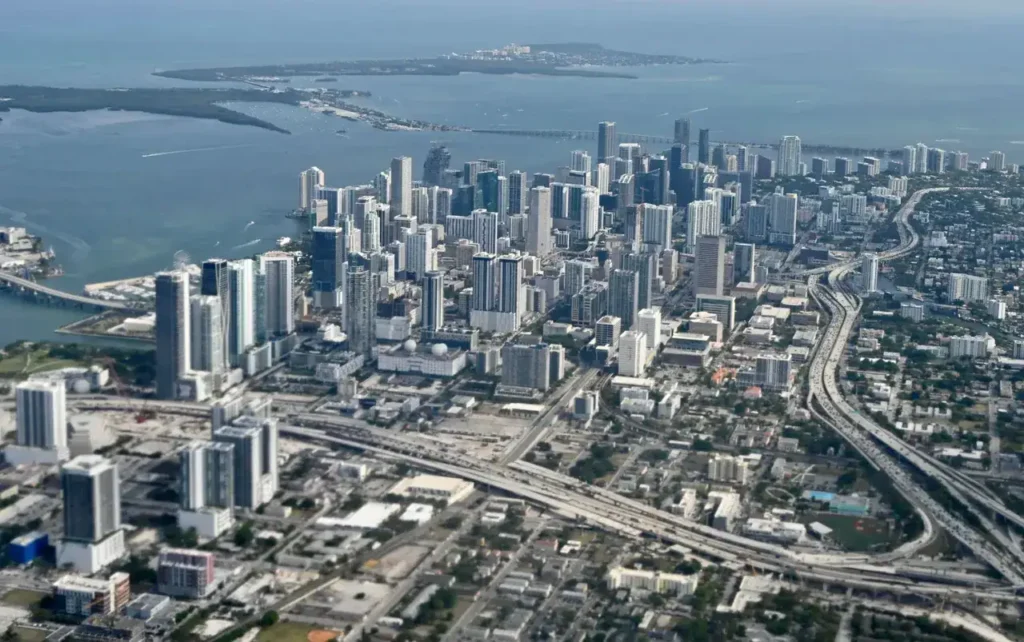Aerial view of Miami skyline featuring high-rise buildings and highways, relevant to billboard advertising strategies in urban settings.