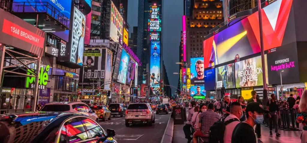 Busy Times Square at night, featuring vibrant digital billboards and advertisements, showcasing the impact of digital out-of-home advertising.