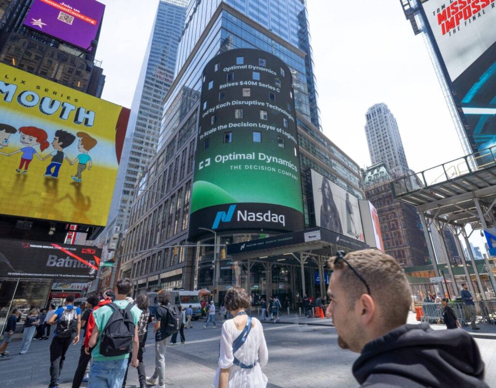 Billboard advertising for Optimal Dynamics and Nasdaq in Times Square, showcasing marketing strategies and digital media engagement.