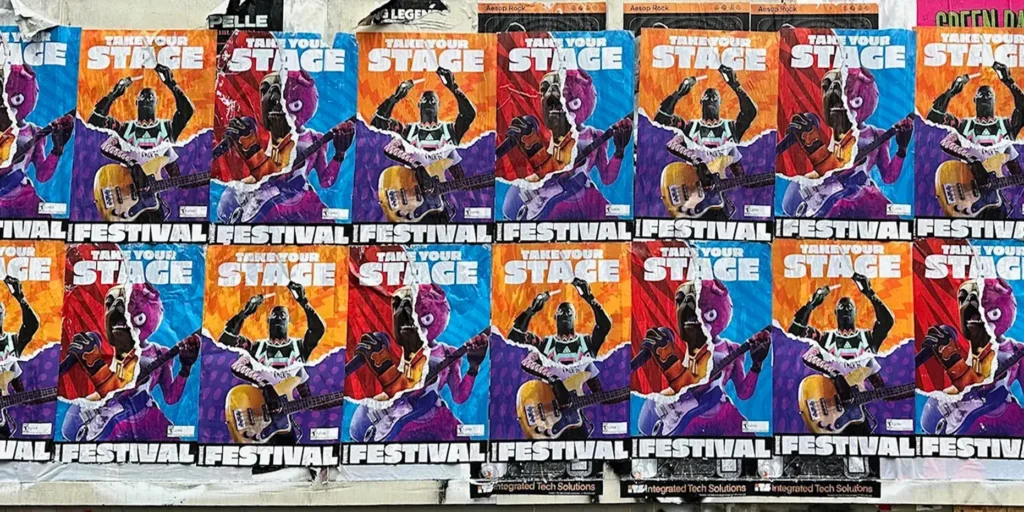 Colorful street posters promoting a music festival, featuring vibrant graphics of musicians and the text "Take Your Stage" and "Festival Lifestyle."