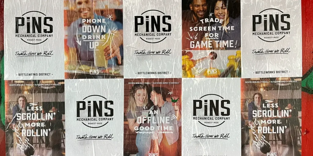 Promotional posters for PiNS Mechanical Company featuring slogans encouraging social interaction and offline activities, including "Phone Down, Drink Up" and "Trade Screen Time for Game Time," set in a vibrant atmosphere.