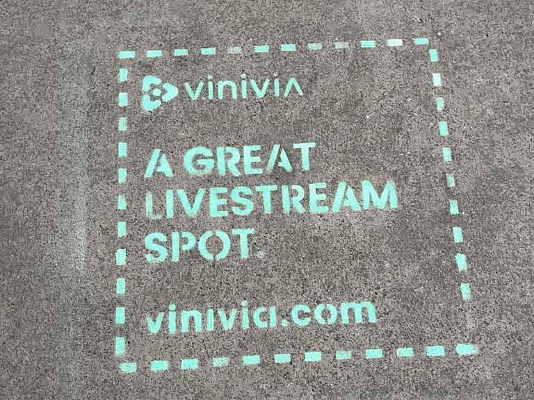 Vinivia marketing stencil on pavement promoting a great livestream spot with website vinivia.com.