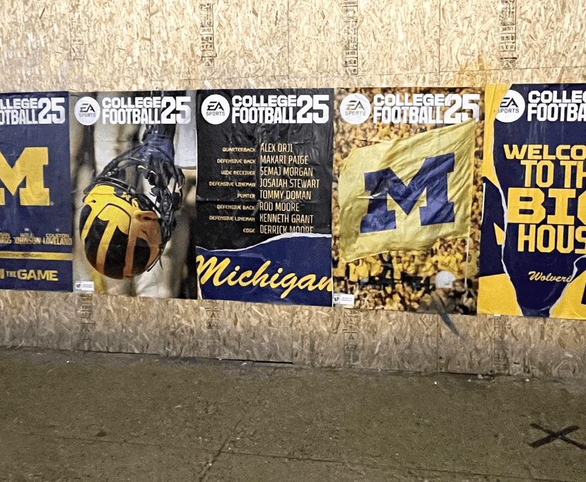 Posters promoting college football featuring Michigan's branding, including a helmet, team roster, and flag, highlighting college sports marketing strategies.