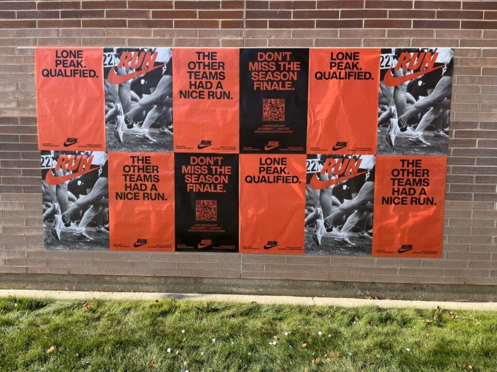 Posters advertising a Nike running event, featuring bold text such as "LONE PEAK. QUALIFIED." and "DON'T MISS THE SEASON FINALE," displayed on a brick wall, emphasizing guerrilla marketing tactics for university sports promotions.