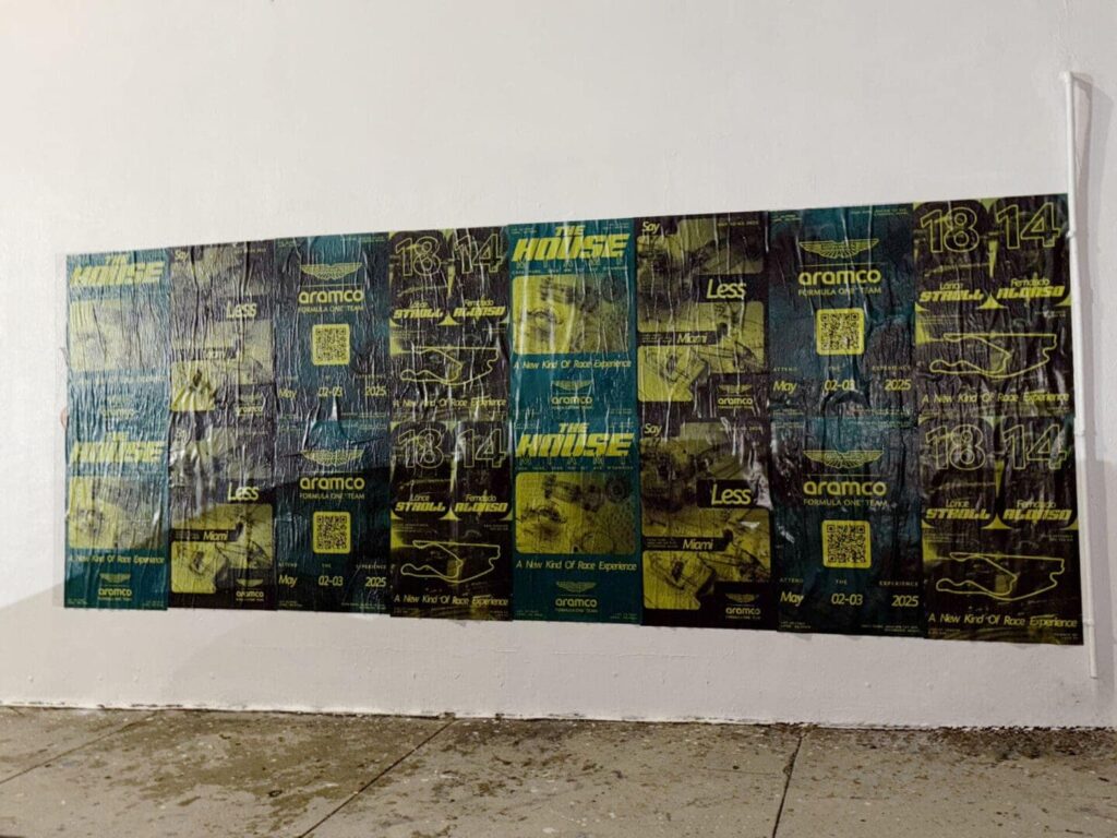 Wall covered with guerrilla marketing posters featuring QR codes, promotional text, and graphics, relevant to experimental marketing tactics for events and college campaigns.