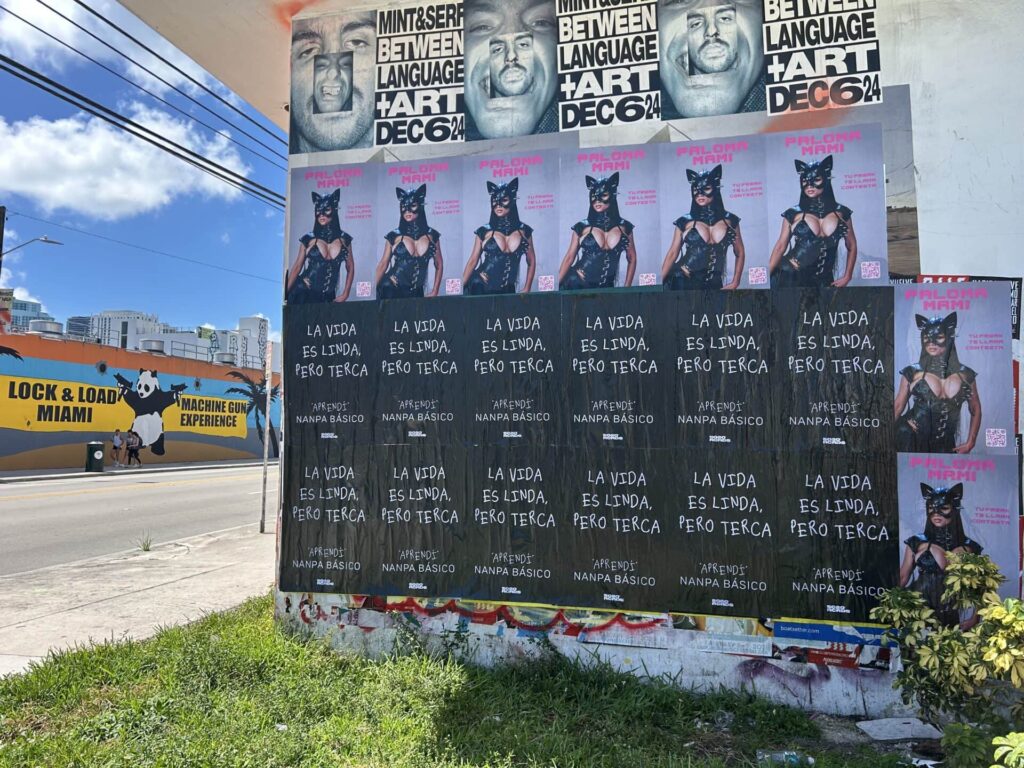 Posters promoting guerrilla marketing strategies featuring a model in a cat costume, with text in Spanish reading "La vida es linda, pero terca," alongside advertisements for local events and businesses in an urban setting.