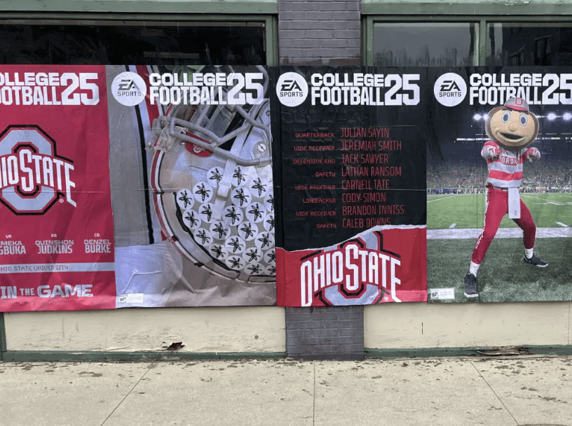 Banners promoting Ohio State University football featuring team helmet and mascot, highlighting players and "College Football 25" branding, emphasizing guerrilla marketing in sports.