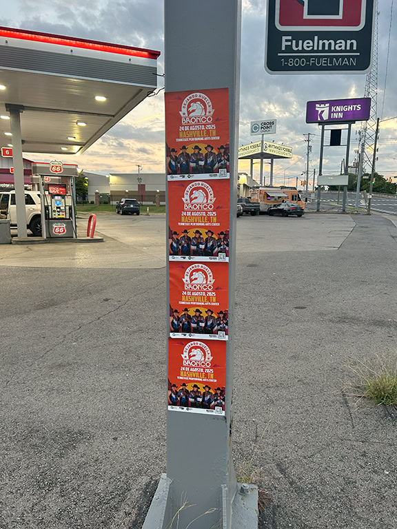 Posters on pole near gas station.