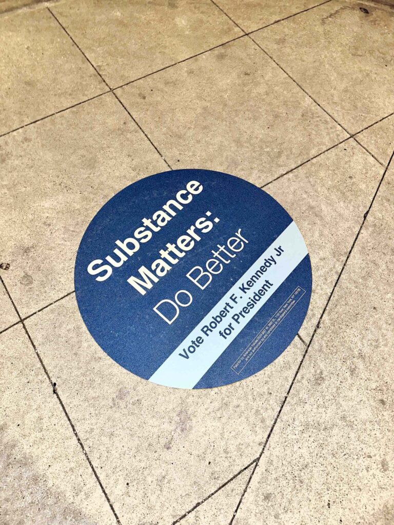 Campaign sticker on tiled floor.