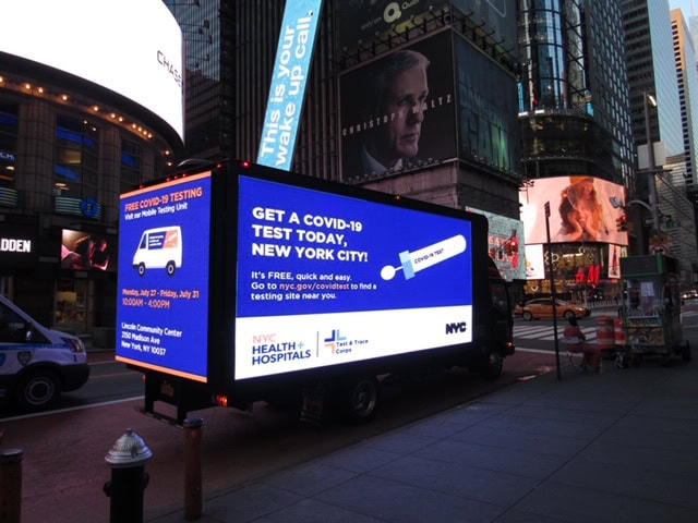 Mobile COVID-19 testing advertisement in Times Square.