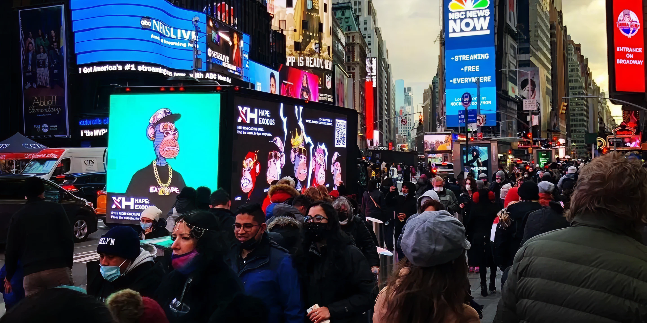 Crowd in Times Square with vibrant digital billboards showcasing animated characters, promoting guerrilla marketing strategies and brand engagement.
