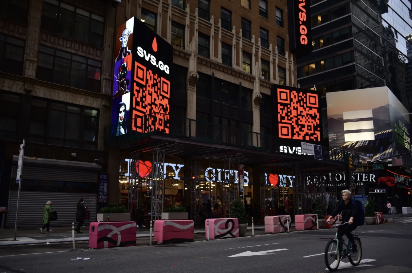 Billboard advertising with digital displays featuring QR code and branding for SVS.GG, located on a prominent building in an urban setting, showcasing outdoor advertising effectiveness.
