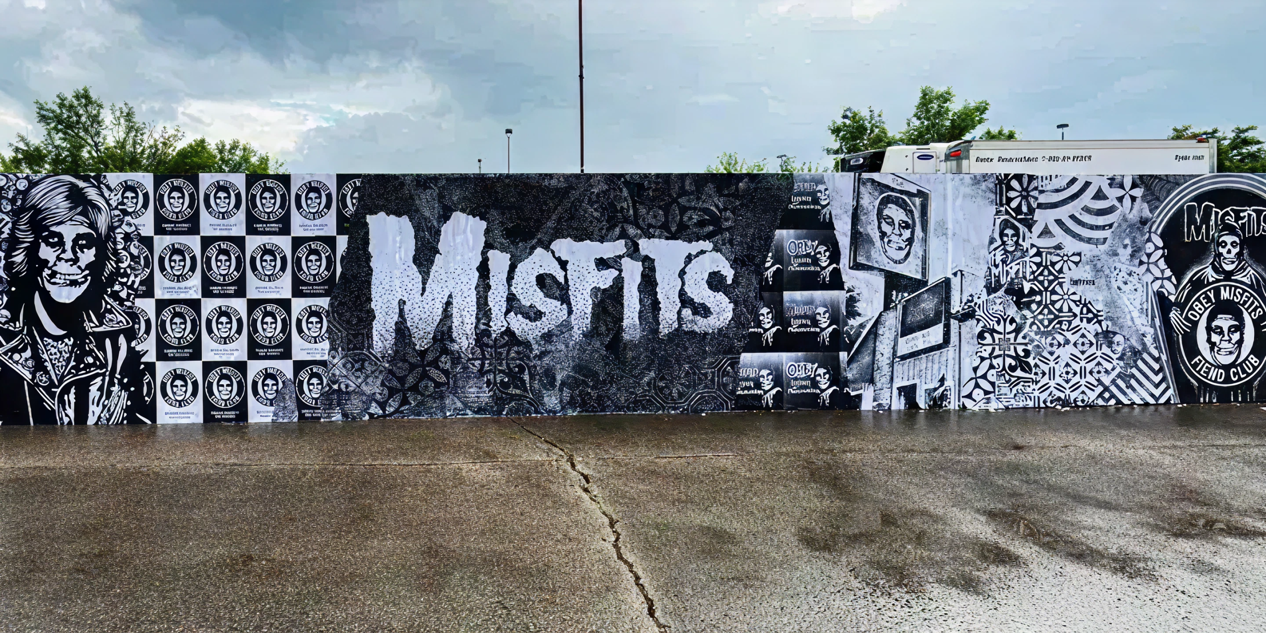 Wheatpaste mural featuring bold "MISFITS" text and various graphic elements, showcasing urban guerrilla marketing creativity and high-impact advertising strategies.