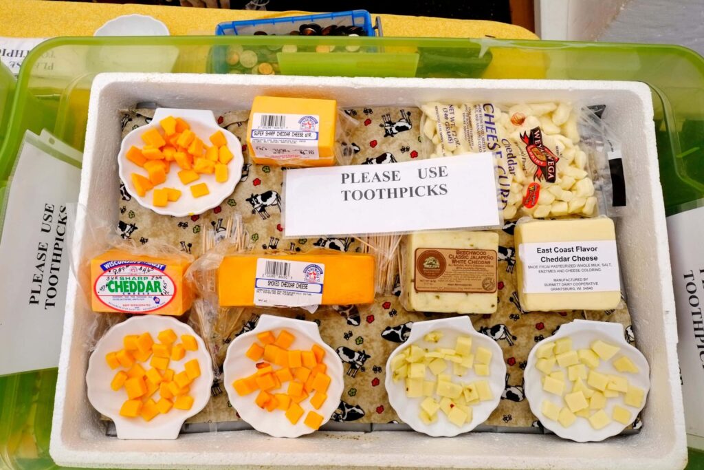 Assorted cheese samples with toothpick sign.