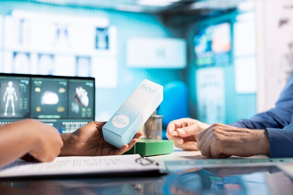 Hands holding medical product in futuristic setting.