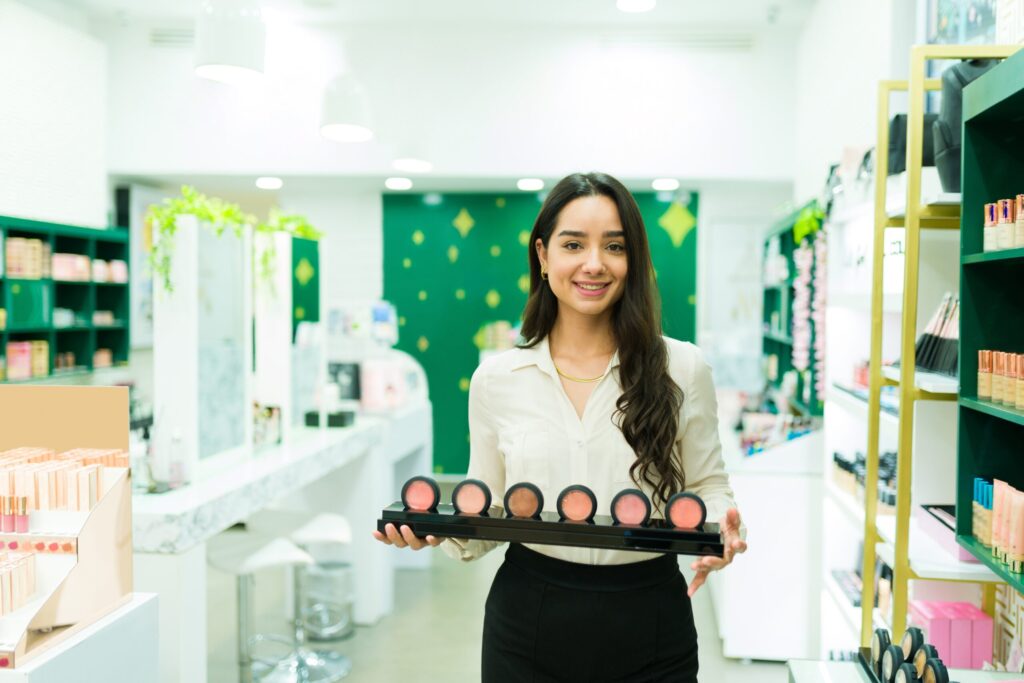 Woman holding makeup palette in store.