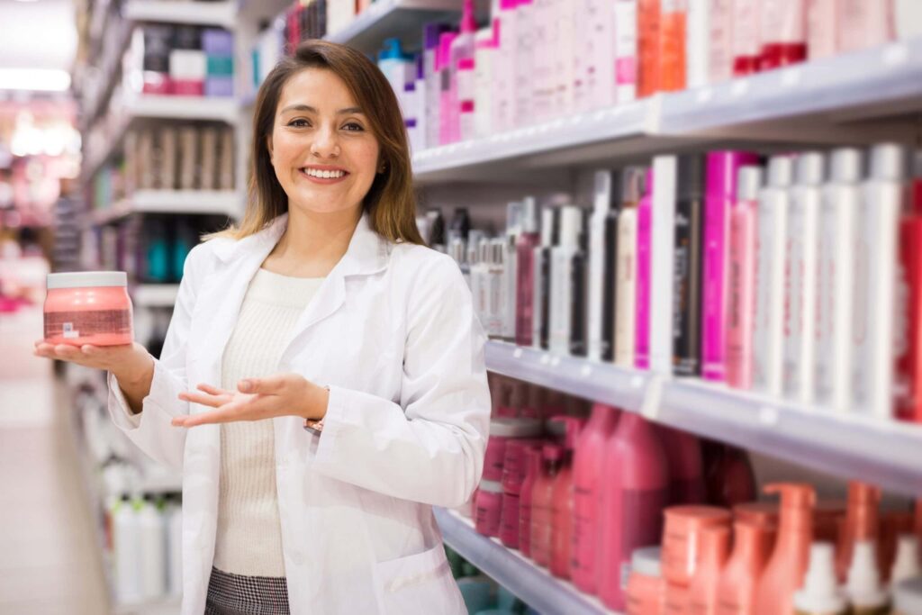 Smiling woman holding product in store aisle.