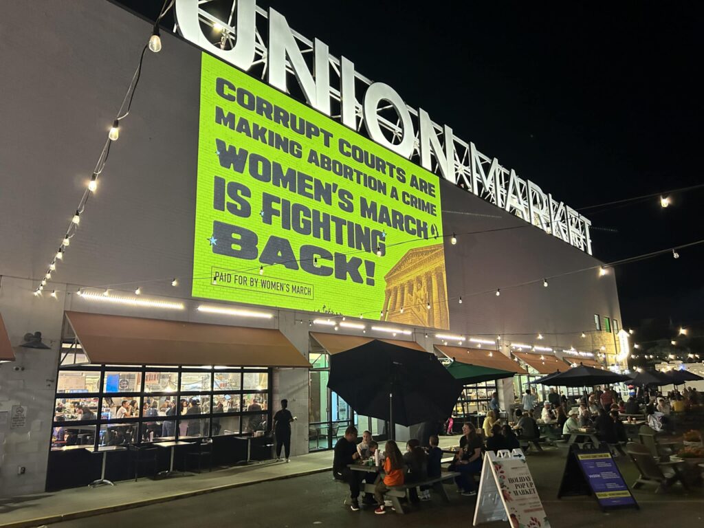 Union Market night scene with protest sign.