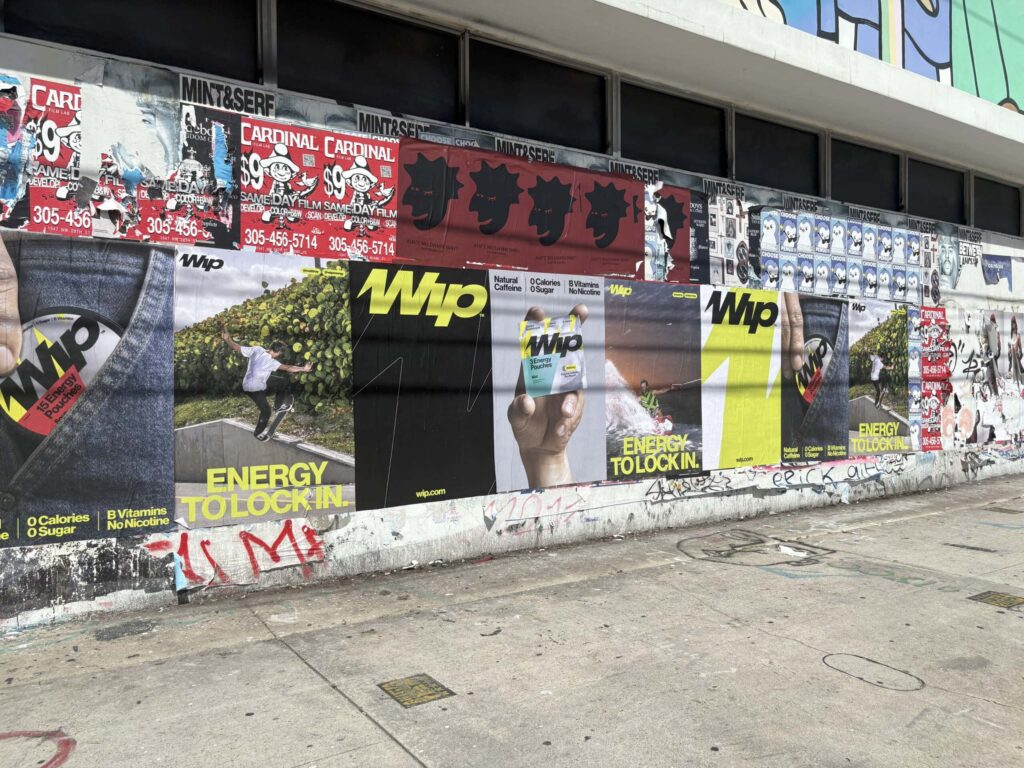Street wall covered with colorful posters.