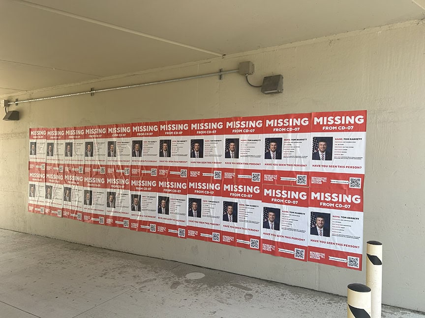 Wall covered with missing person posters.